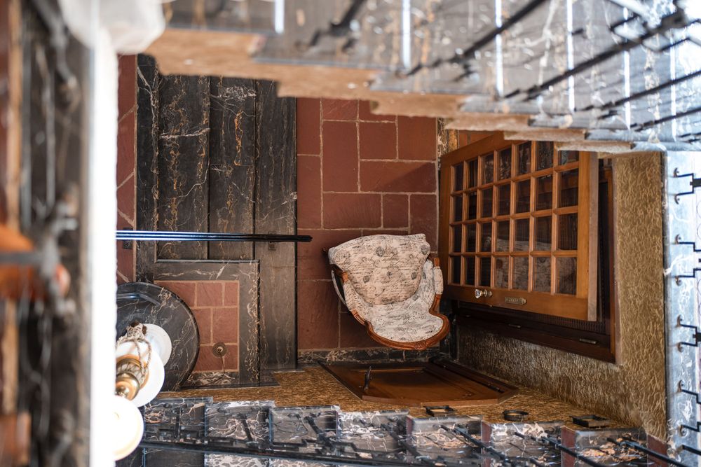 Vintage cellar corner with wooden shelving and stone architectural elements.