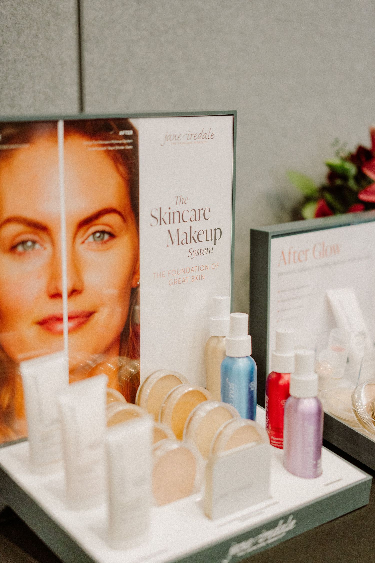 Skincare and makeup display featuring before-and-after imagery with product testers.
