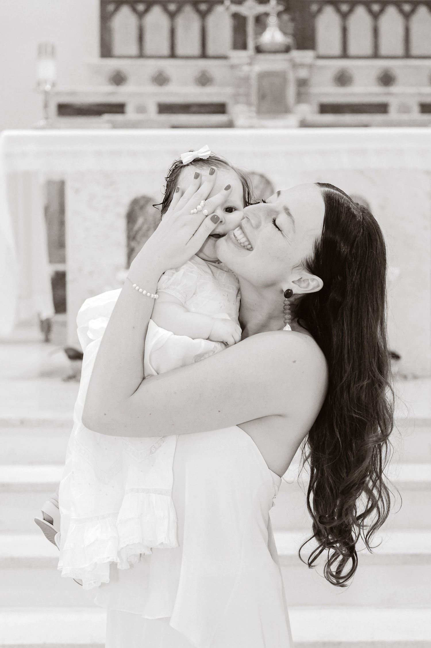 A tender black and white portrait capturing a joyful embrace between parent and child.