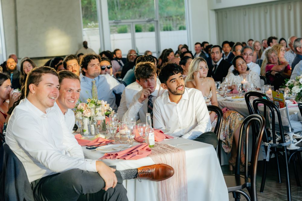 Wedding reception guests enjoying a lively celebration in a modern indoor venue.