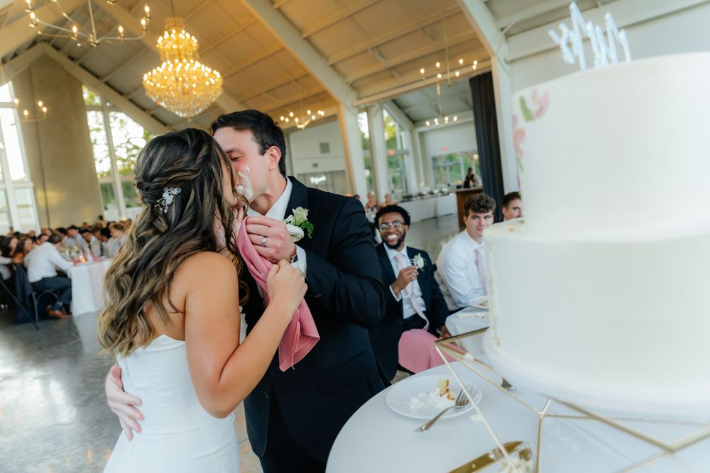 A tender first dance moment between newlyweds under an elegant crystal chandelier in a grand reception hall.