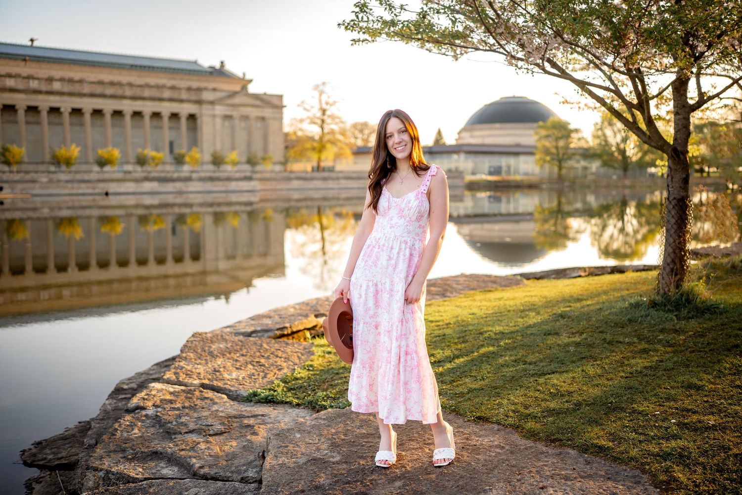 A pink sundress worn near a reflective pool at sunset with the Palace of Fine Arts dome in San Francisco.