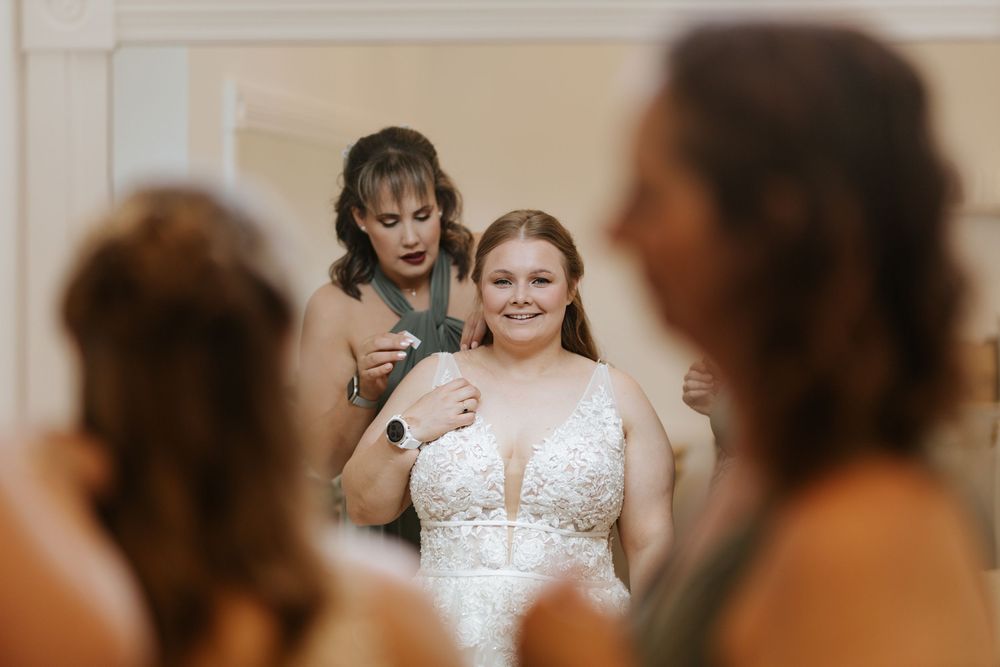 Wedding party celebrates in an elegant indoor venue with joyful expressions and formal attire.