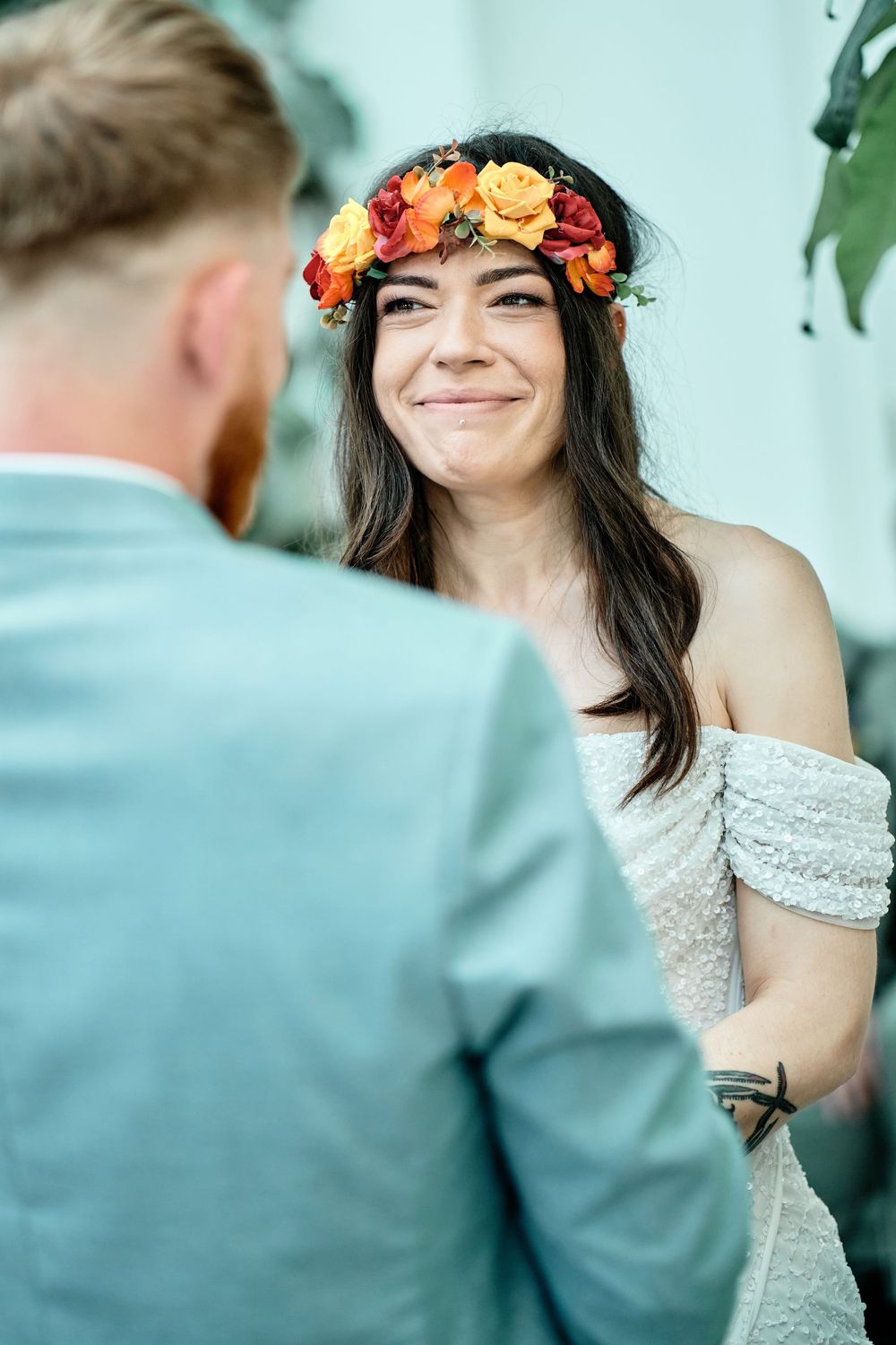 Four romantic wedding photos show a bride with a floral crown and off-shoulder lace dress sharing happy moments with a groom.