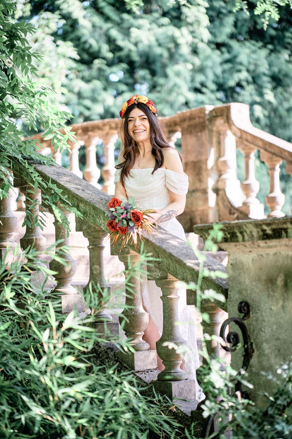 A romantic garden photoshoot featuring elegant stone balustrades and lush greenery creating a dreamy summer atmosphere.