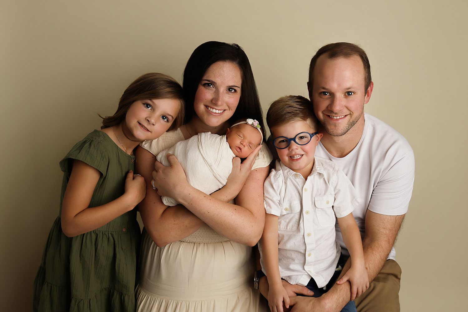 Utah newborn photos A series of five warm-toned family portrait photographs arranged horizontally showing intimate family moments together.d