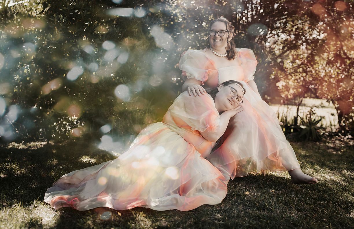 A dreamy coordinated photo series shows a person in pink flowy fabric against a magical woodland backdrop.