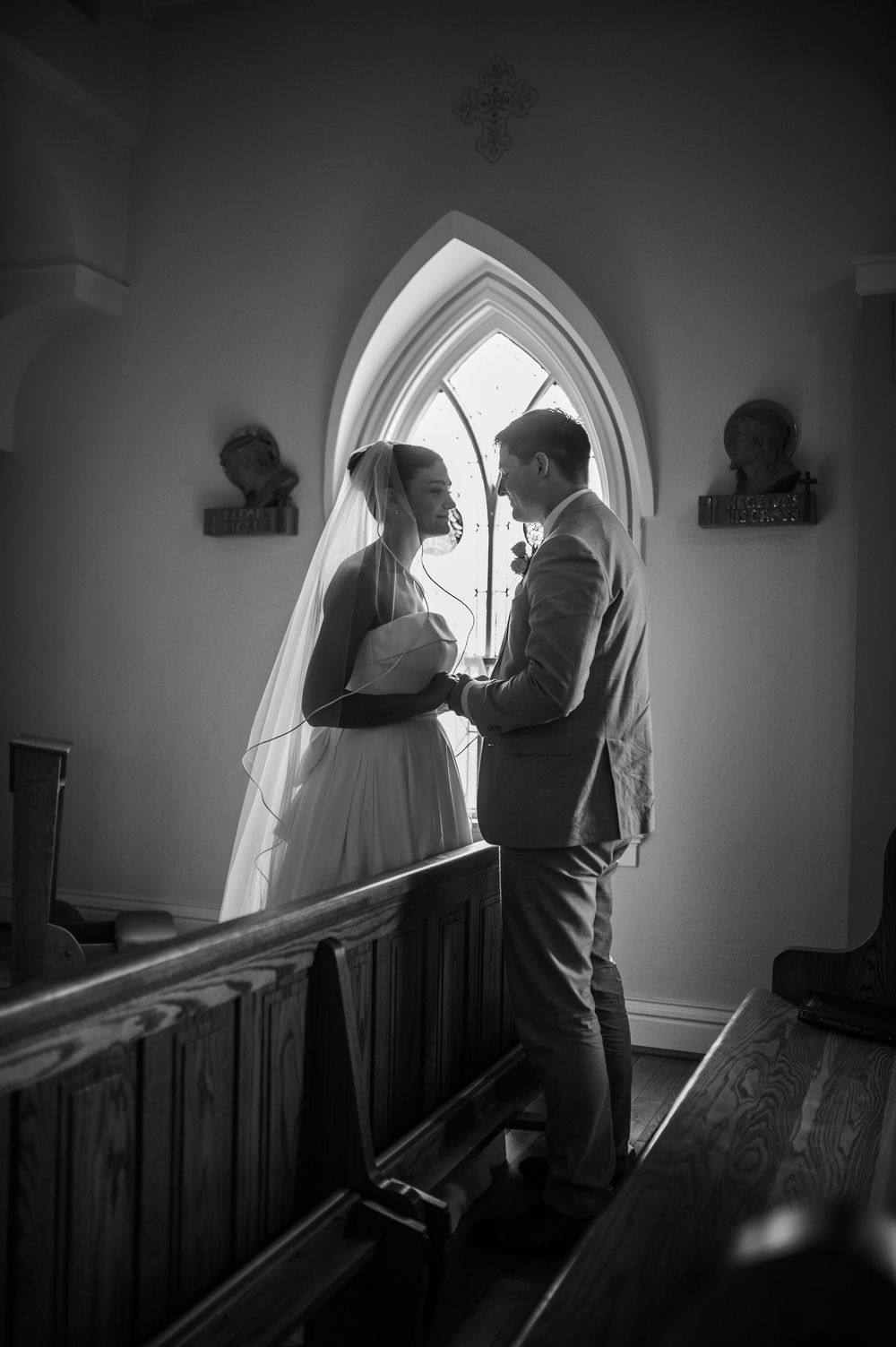 A black and white multi-panel sequence shows two figures standing near an arched church window in dramatic lighting.