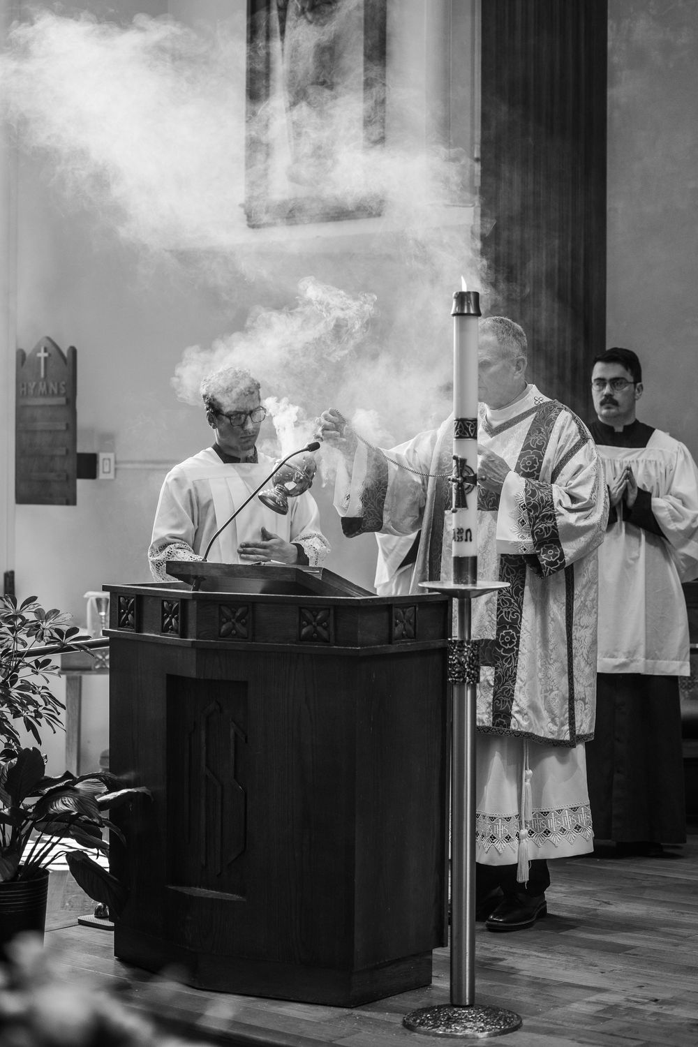 Black and white photo sequence showing Catholic mass ritual with incense smoke rising from thurible during religious ceremony.
