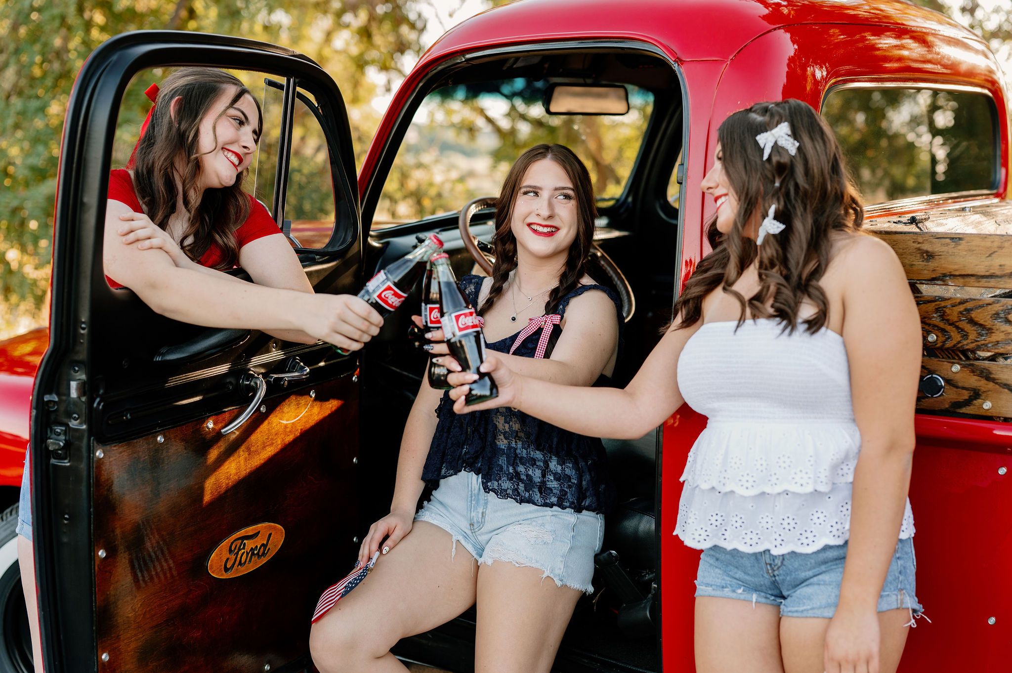 Patriotic senior pictures with vintage Coke bottles and a vintage red truck