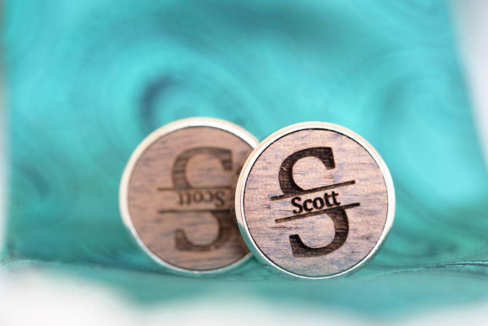 Artistic wooden signs and decorative pieces for wedding decor arranged on a turquoise background.