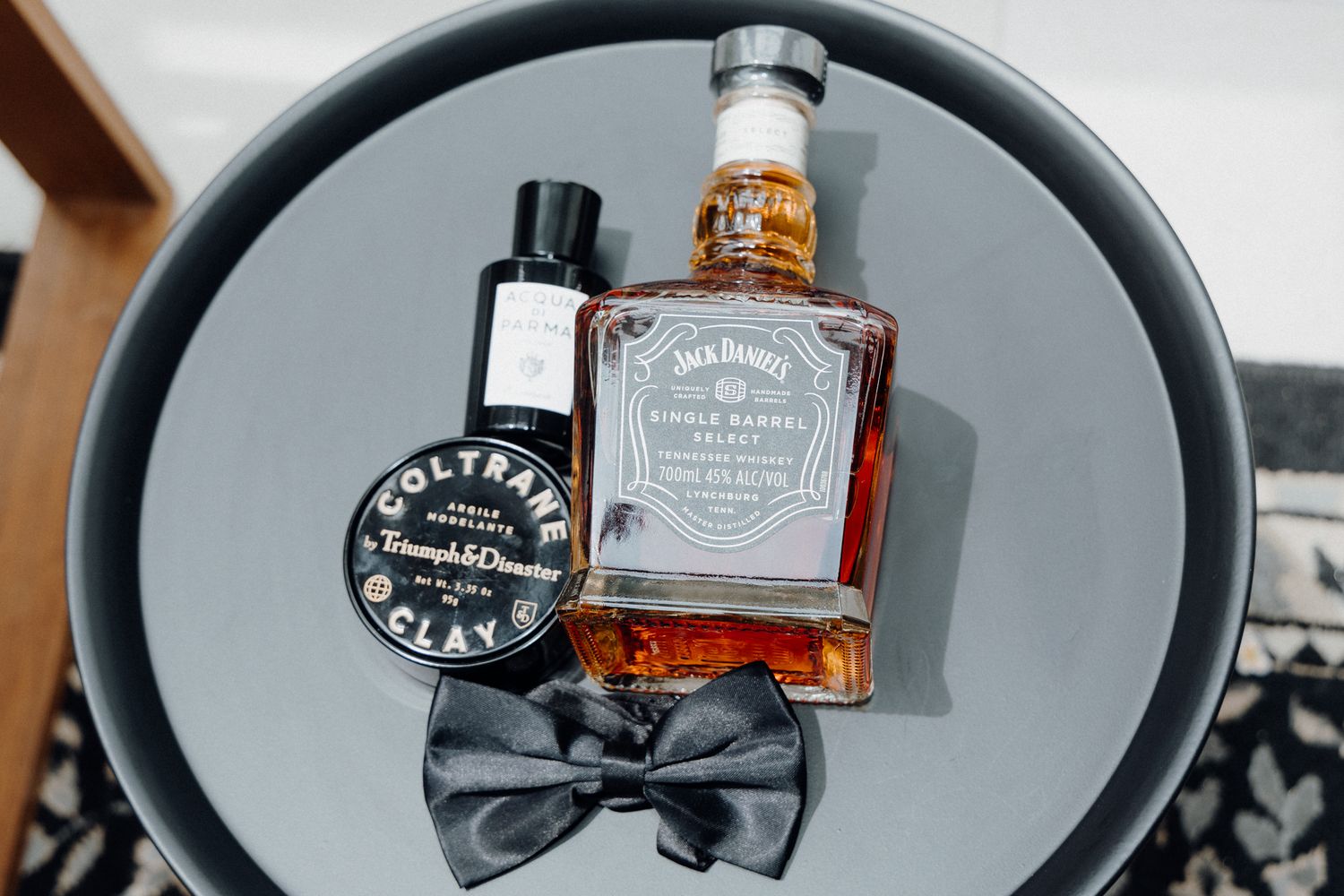 A bottle of Jack Daniel's whiskey and a black bow tie captured by Apertured Media Auckland Wedding Photographer.