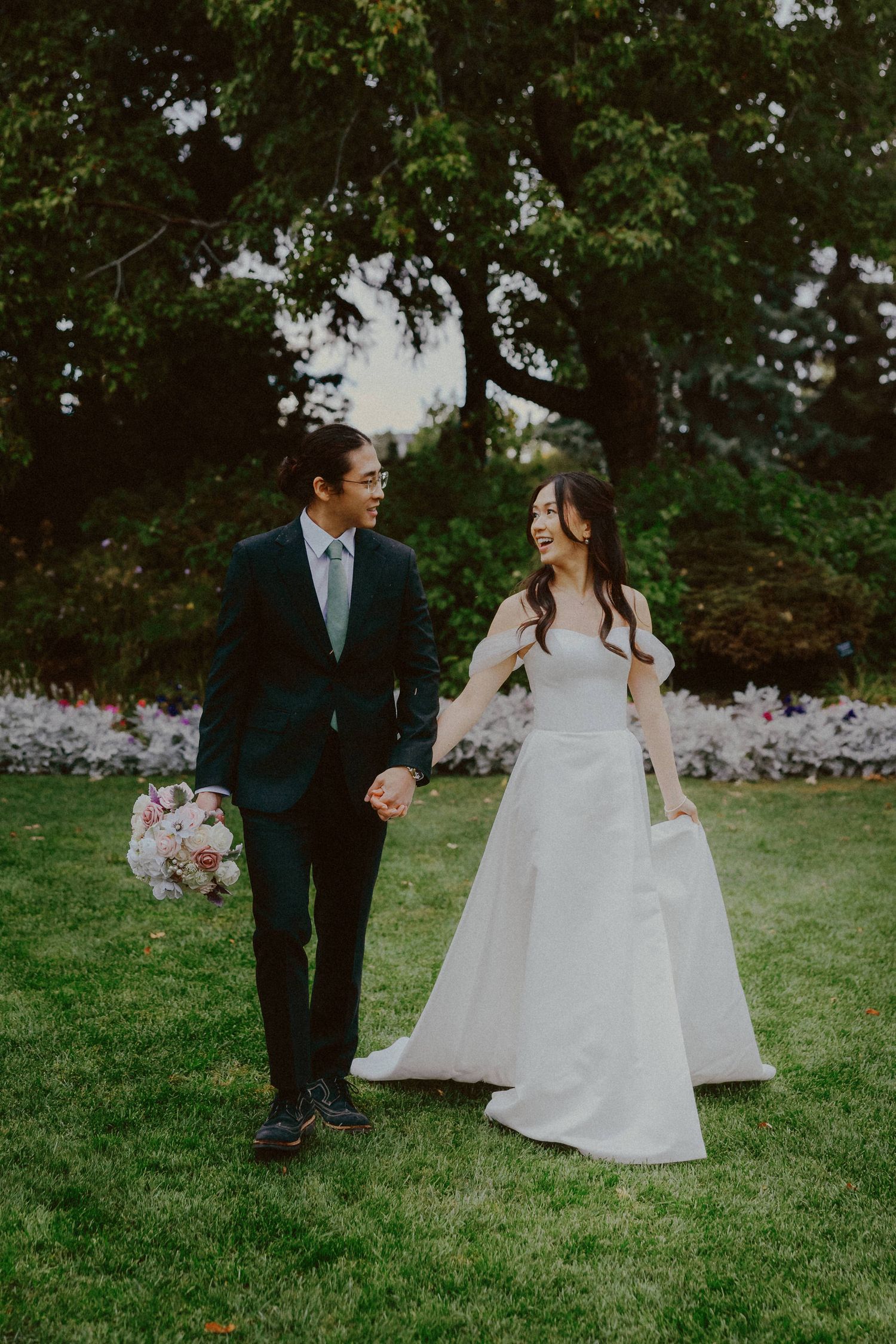 Candid moment between bride and groom at Calgary Zoo, captured by a Calgary wedding photographer focused on authentic love stories.
