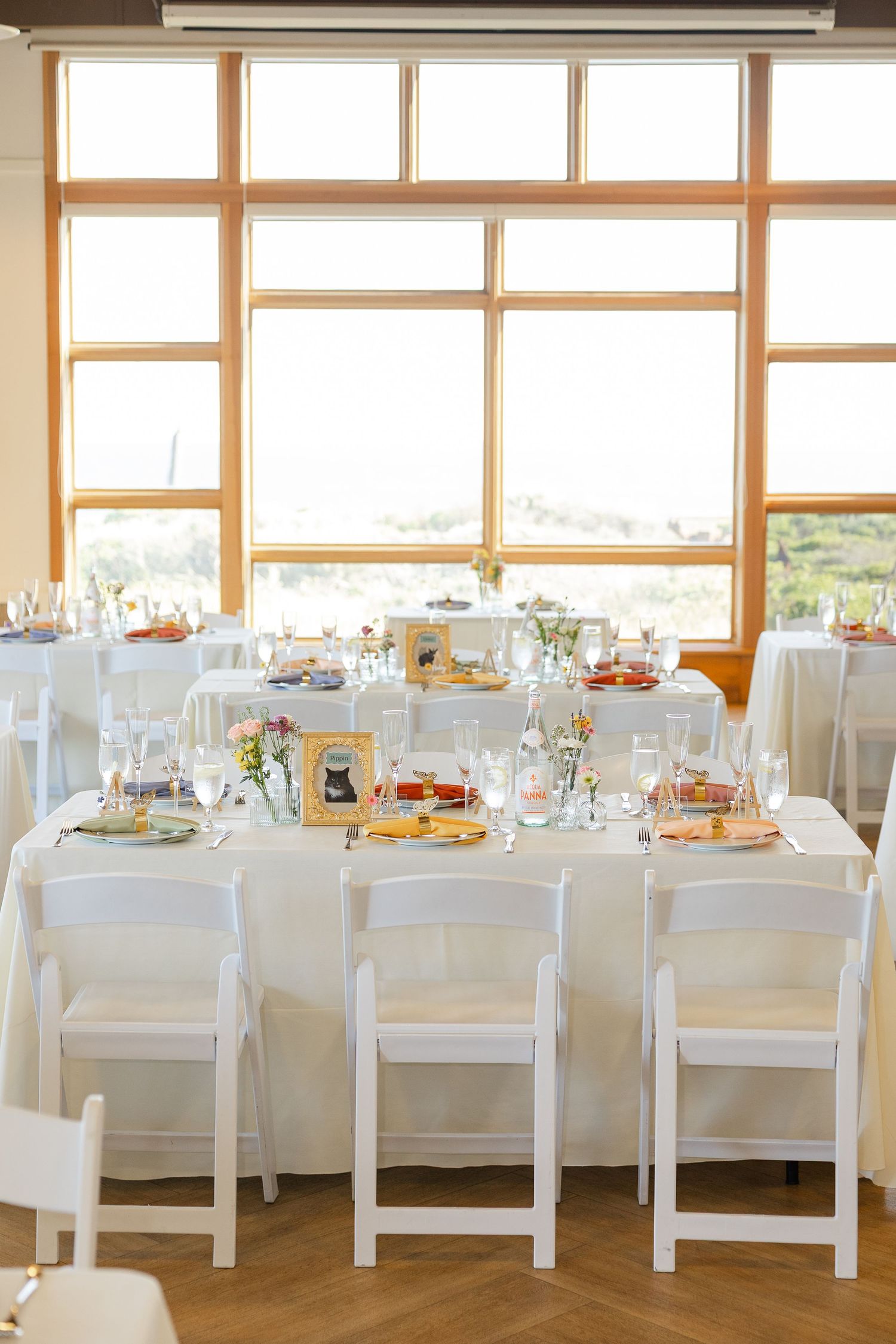 Elegant table setting with vintage floral plates and wooden clothespins on a light colored tablecloth.