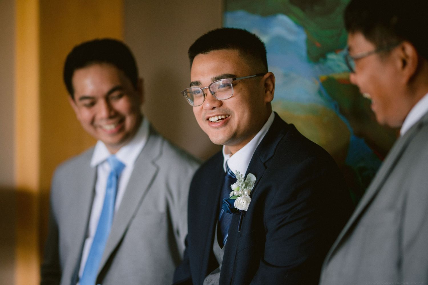 Wedding party members share a joyful moment before the ceremony.