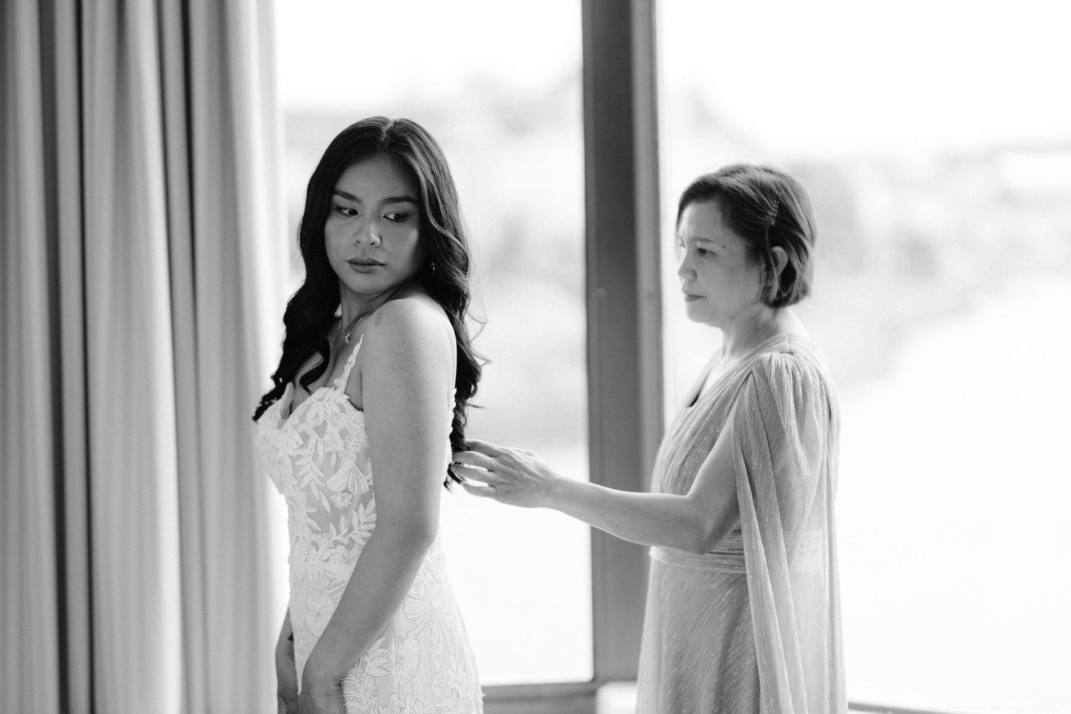 Final wedding dress fitting with delicate lace details in a sunlit room.