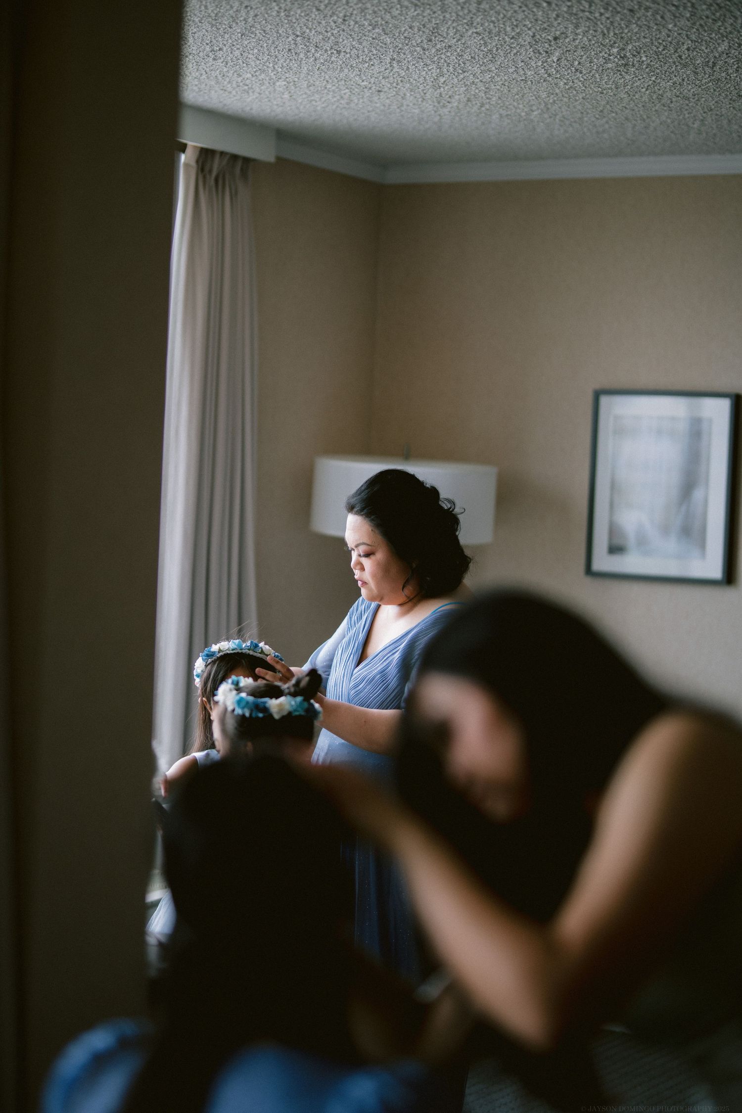 Behind the scenes of wedding preparation in a dimly lit hotel room.