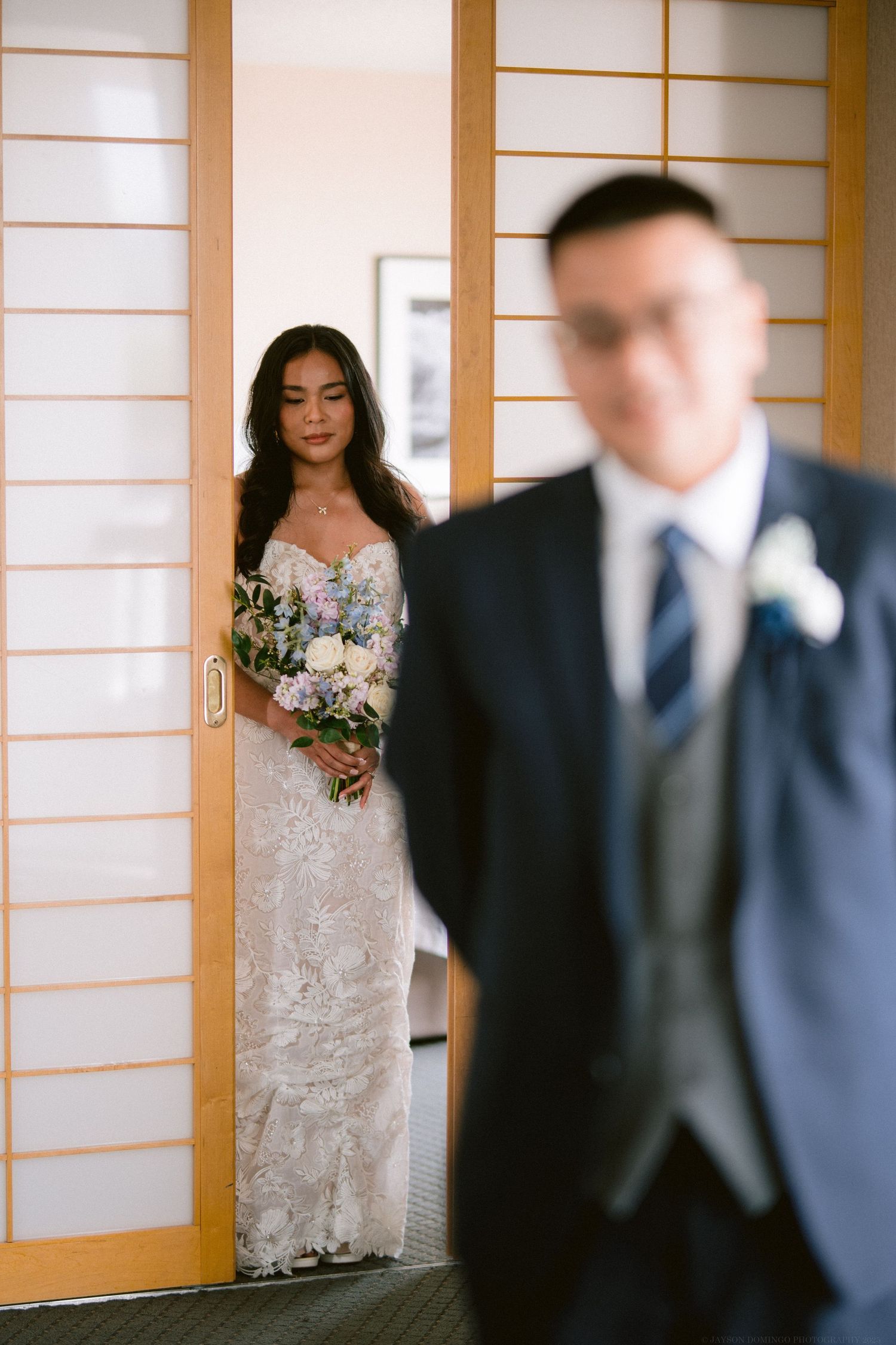 First look wedding moment captured through Japanese-style sliding doors.
