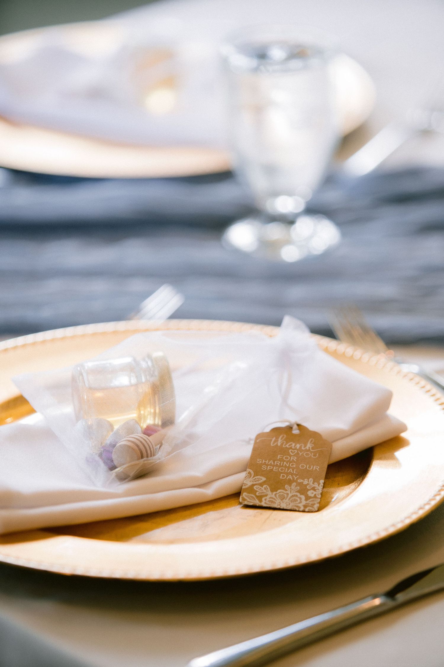 Elegant table setting with gold charger plates and name cards for a formal event.