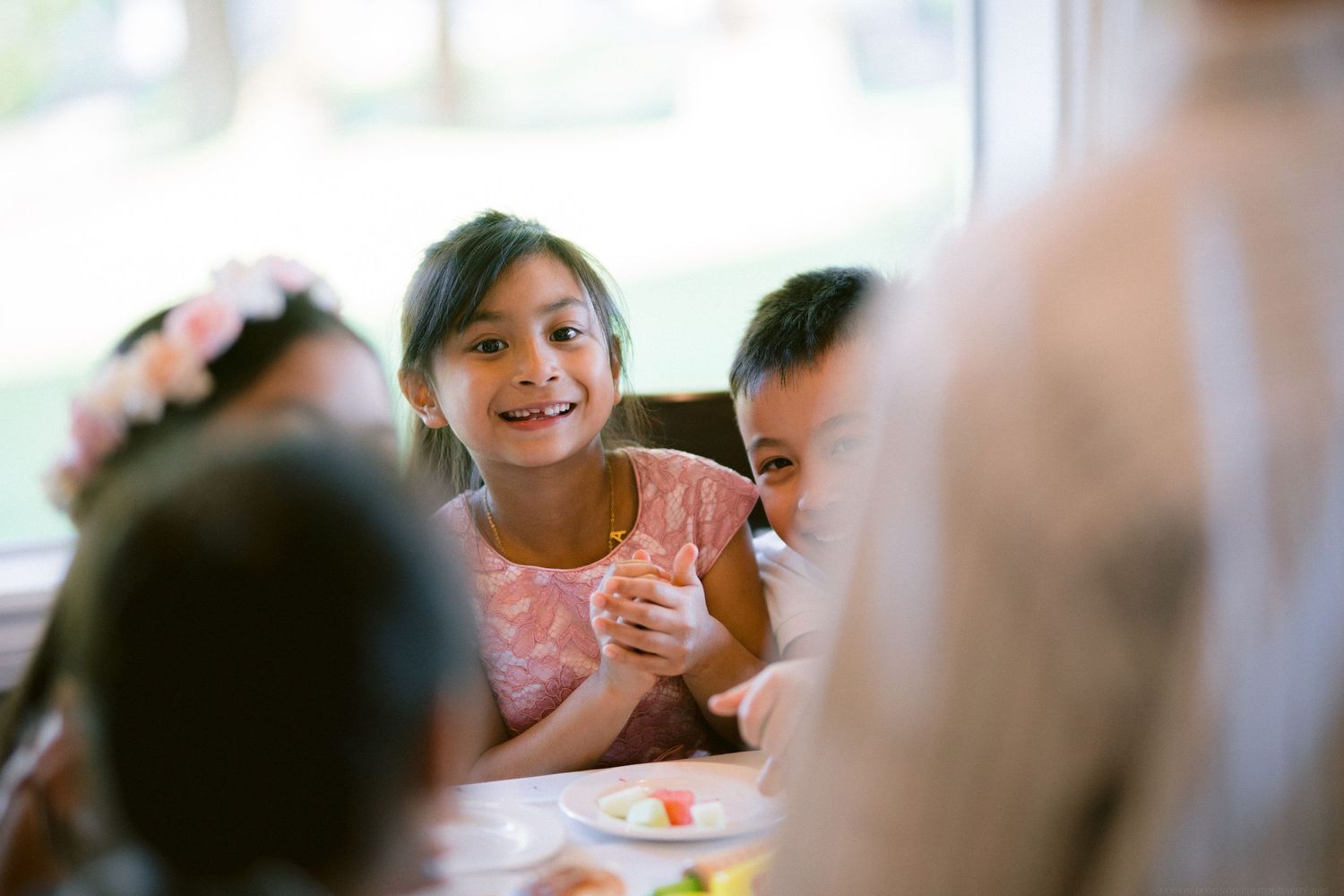 Guests enjoying a joyful moment during a seated reception or dinner party.