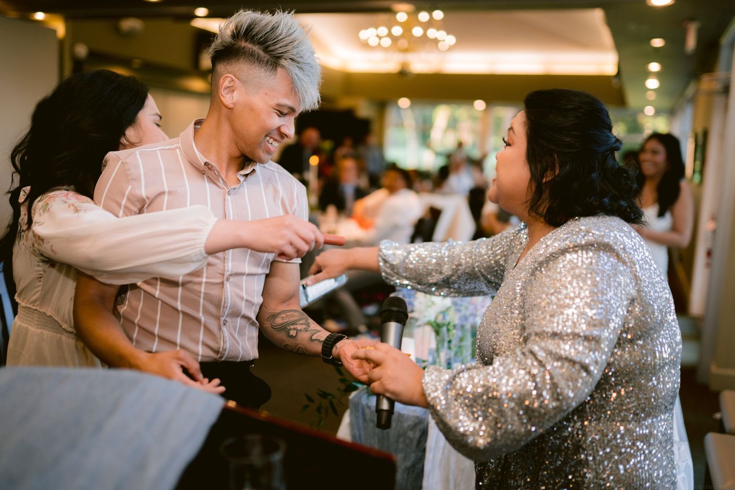 Guests celebrating with energetic dancing and laughter at reception party.