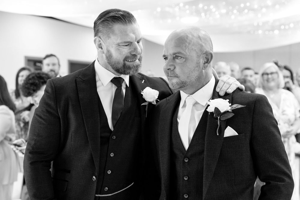 Groom sharing a touching moment with his best man before the wedding ceremony at the Village Hotel, Portsmouth.