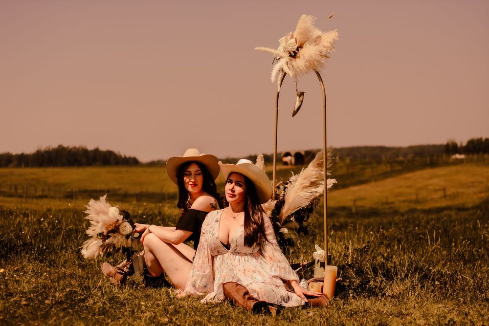 A dreamy sunset photo series of someone in vintage-inspired clothing lounging in a grassy field with wildflowers.