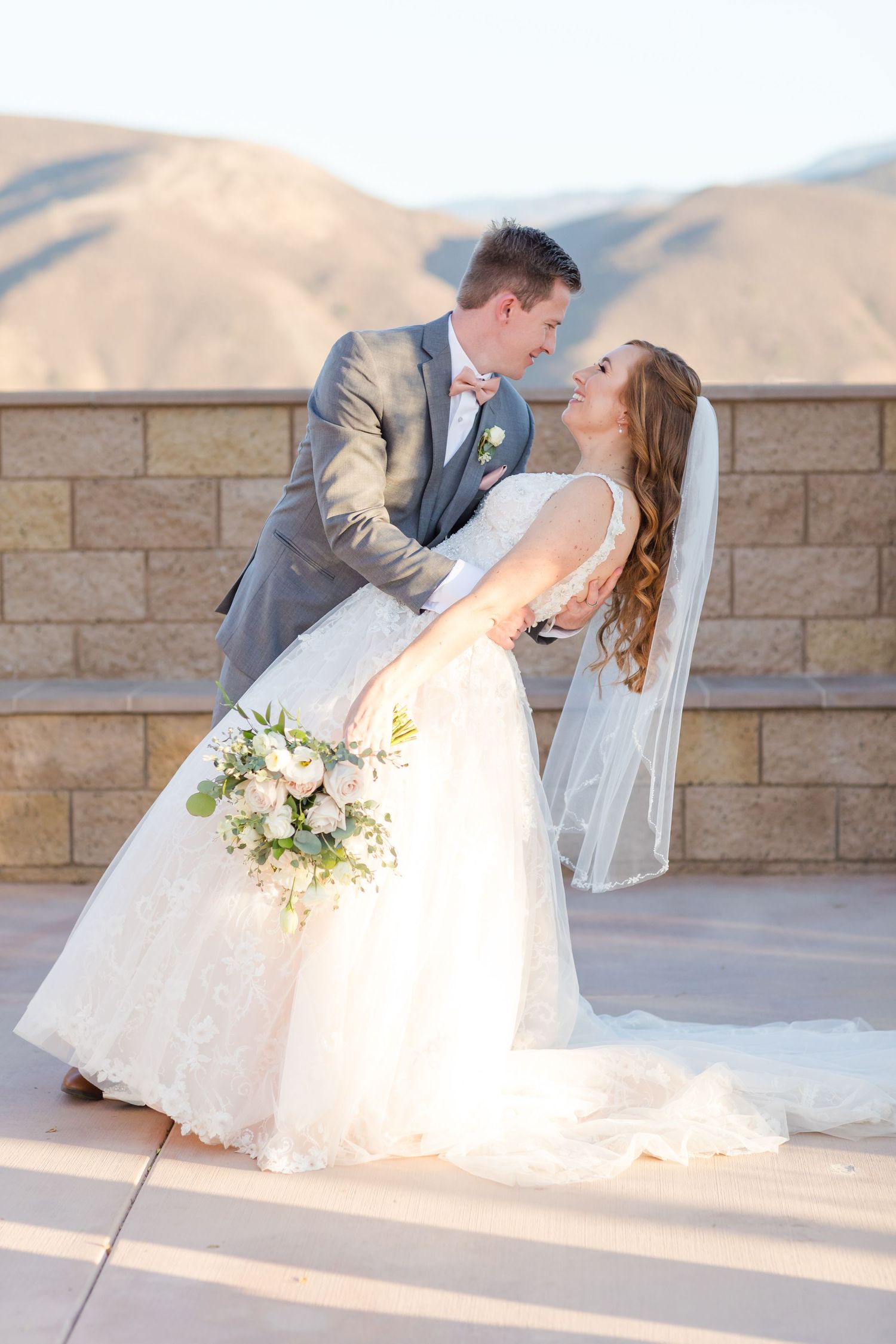 Hubby and wife wedding dip in front of mountains