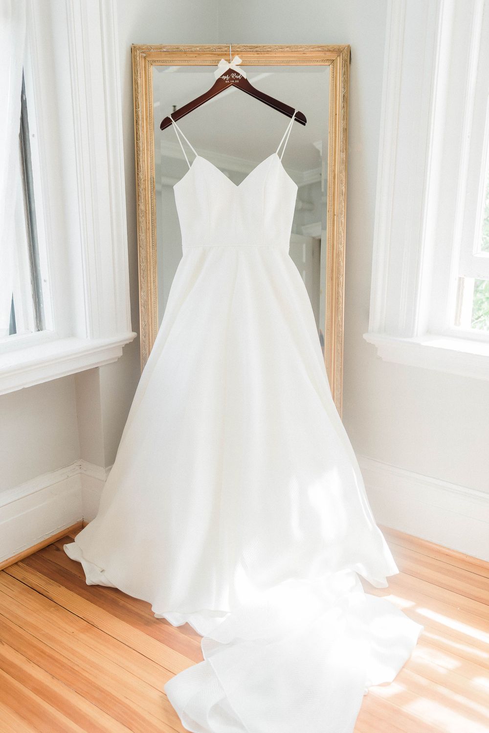 Wedding dress hanging on mirror