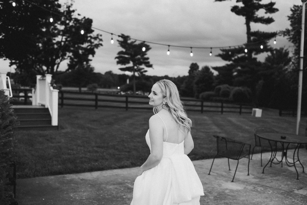 A black and white photo of the bride towards the end of the night
