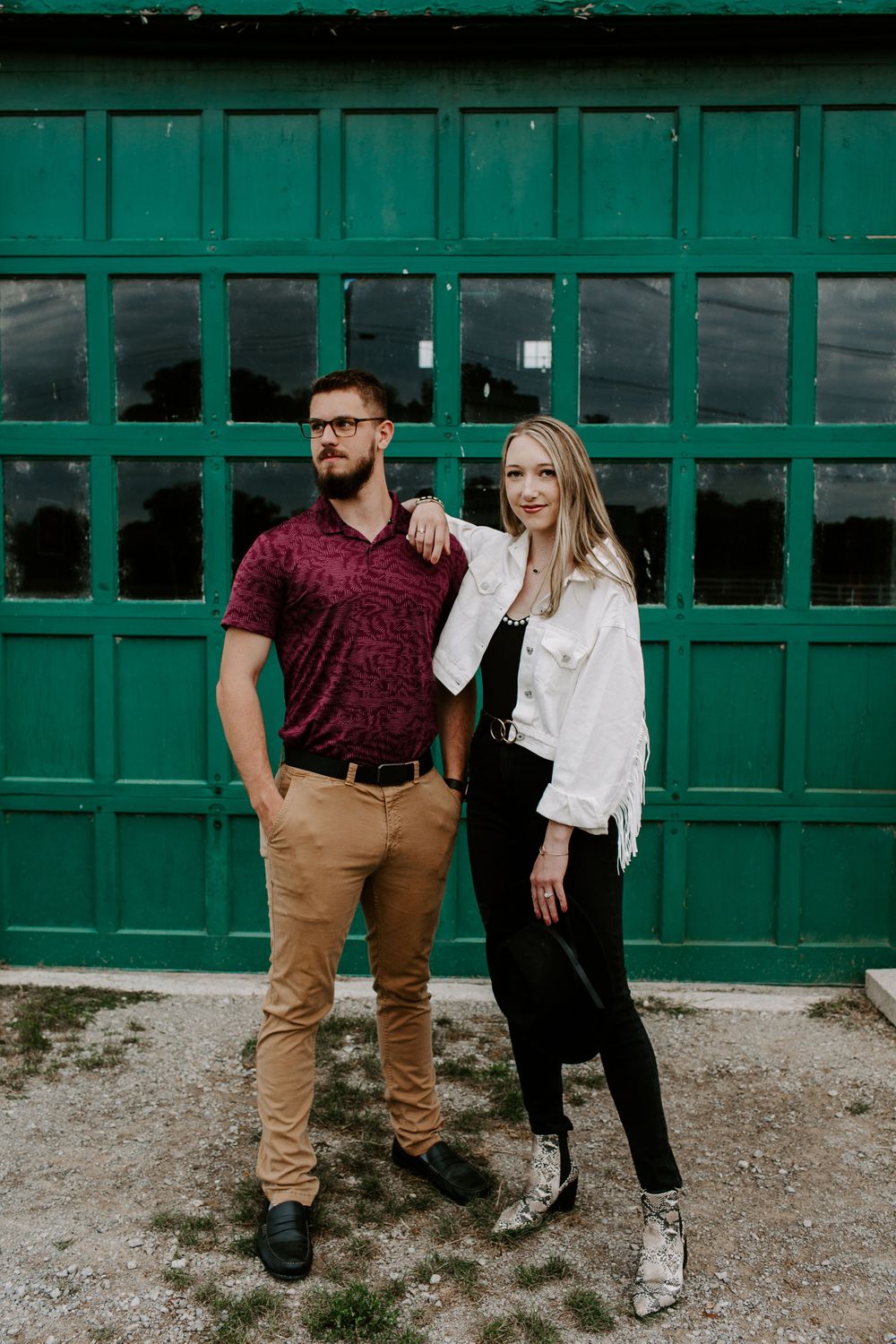 couple posing in front of green door in Nashville tennessee