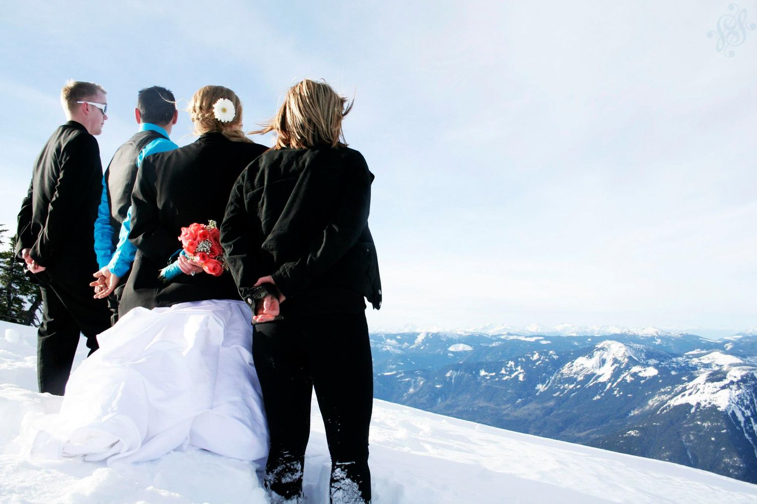 Winter mountain wedding ceremony with snow-capped peaks in background.
