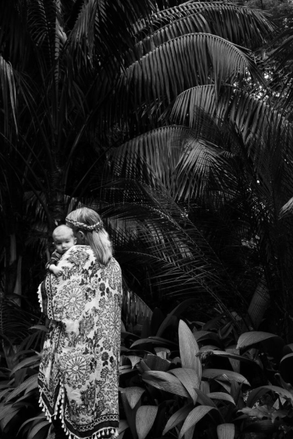 new mother holding baby palm tree black and white