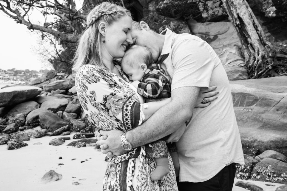 new parents holding baby cuddling sydney