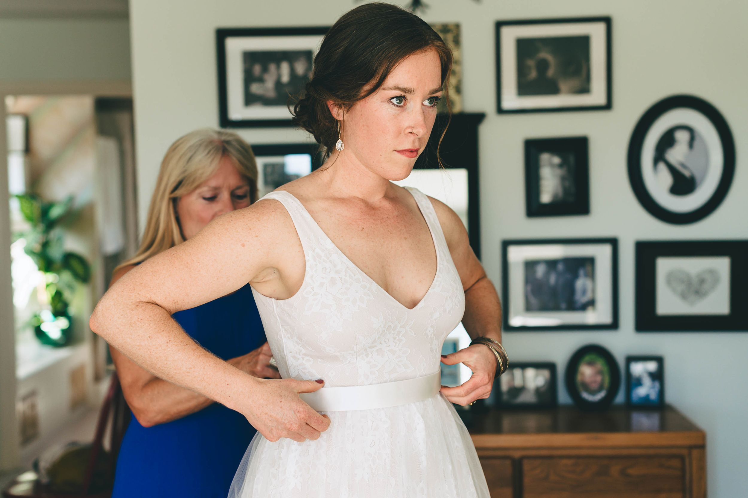bride getting into wedding dress