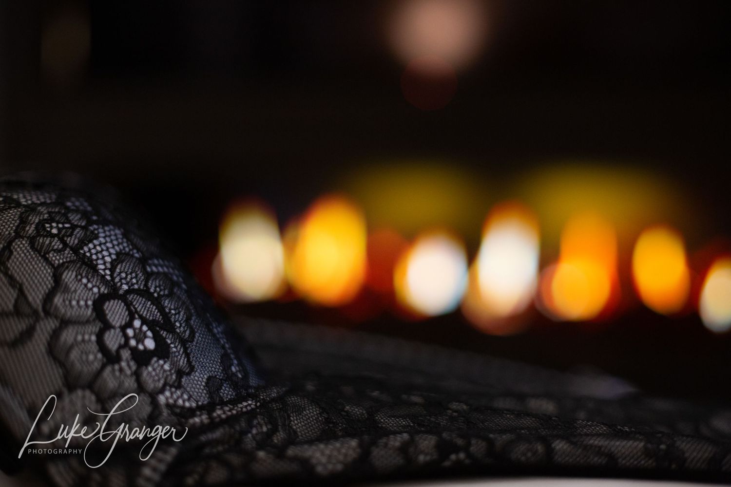 photo showing black lingerie with a fireplace behind
