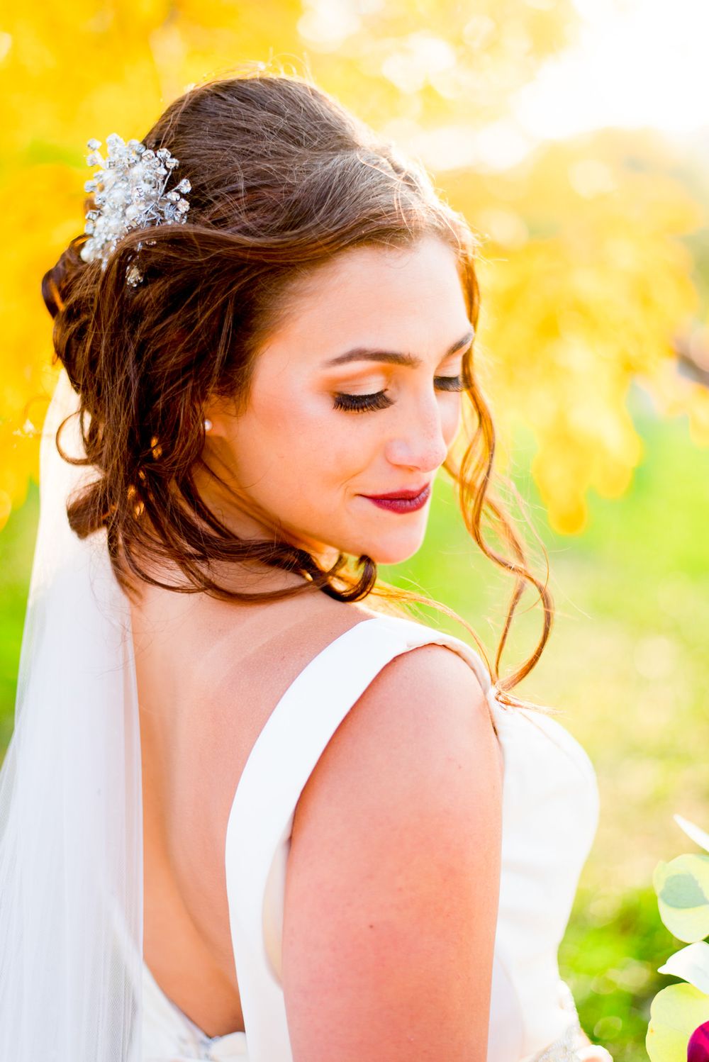 bride with long eyelashes and red lipstick shows her glam look for chicago wedding