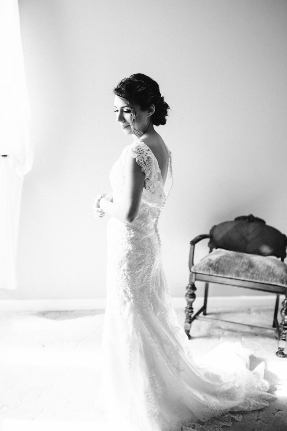 Bride getting ready by window