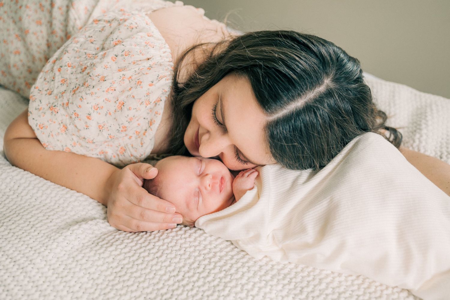 An intimate bonding moment with a sleeping newborn.