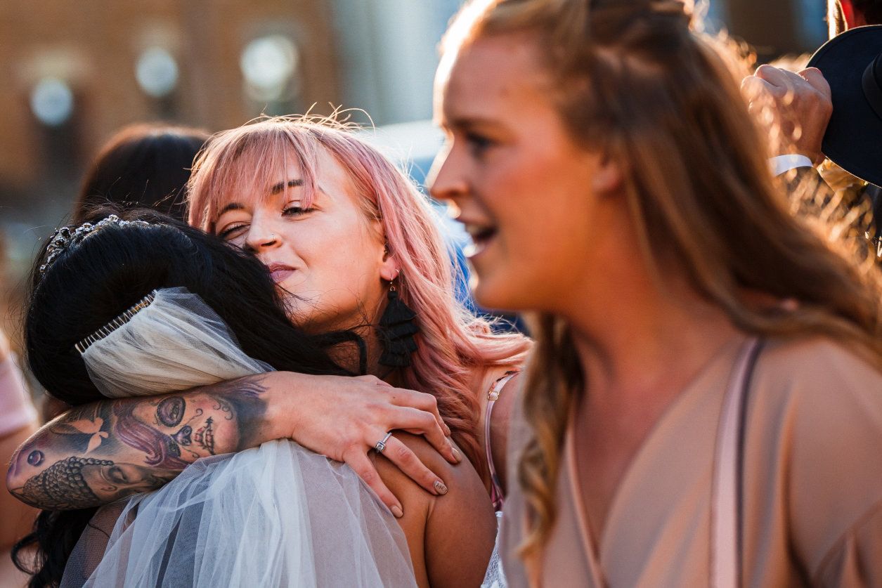 bride hugging guest at wedding reception