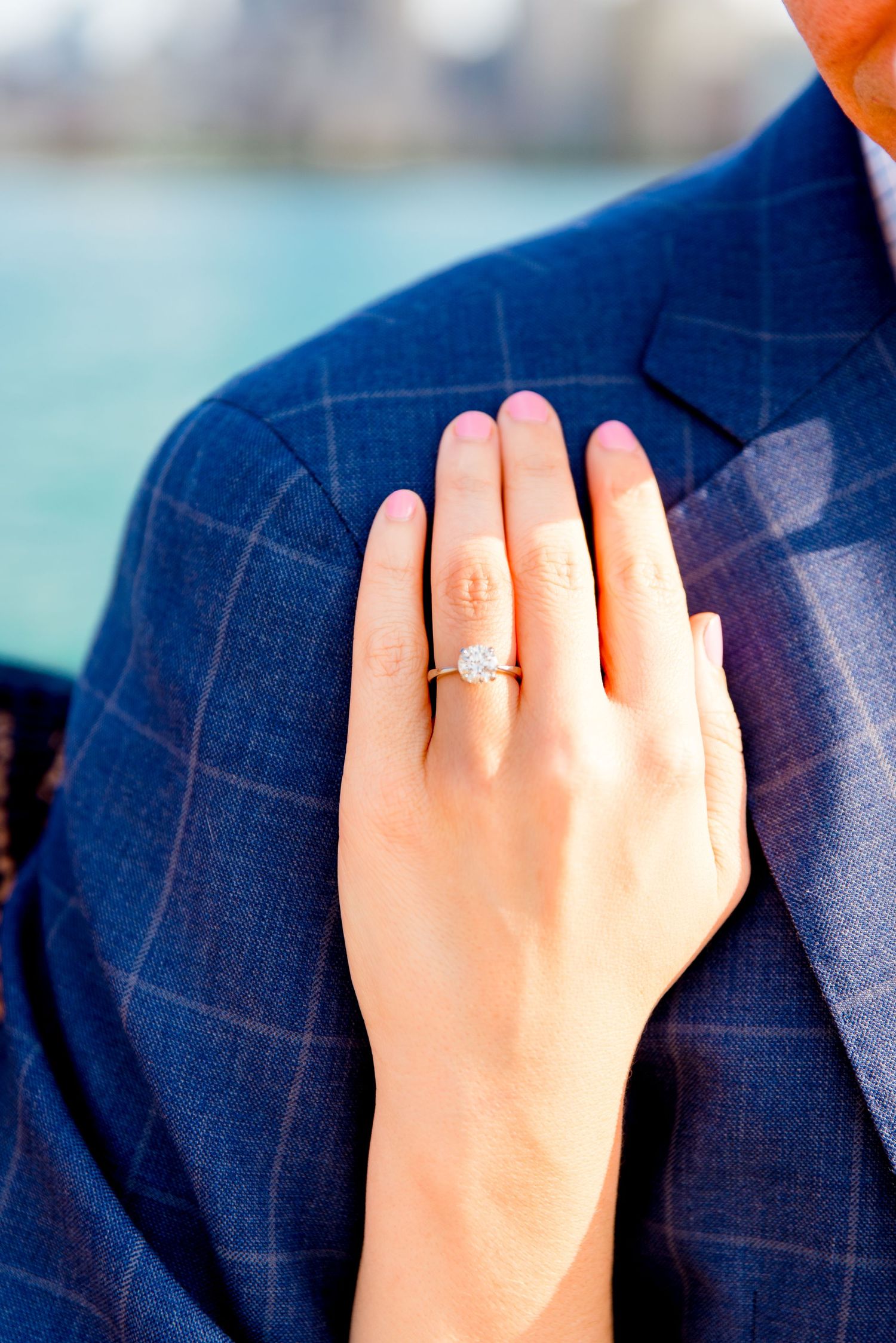 woman's hand with engagement ring on it