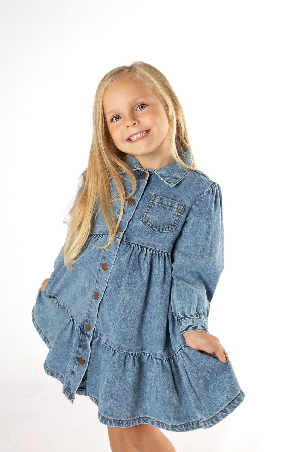 child model in blue denim dress on white background