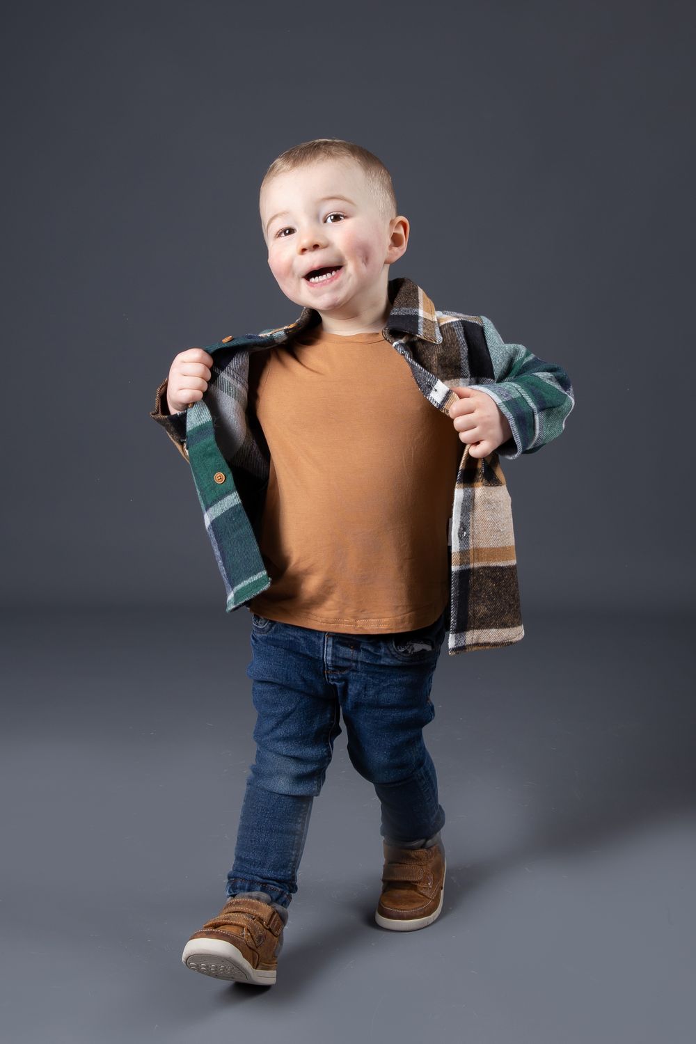 toddler modelling outfit walking holding jacket