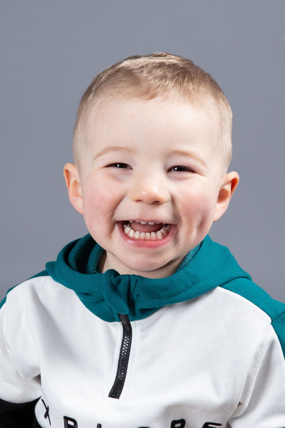 toddler headshot smiling wearing hoodie