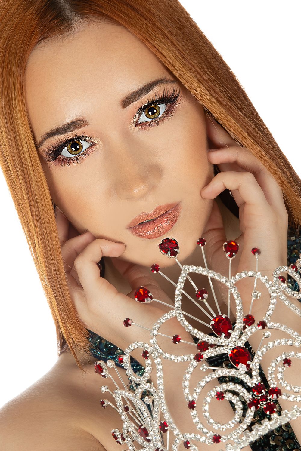 pageant queen with crown over hands