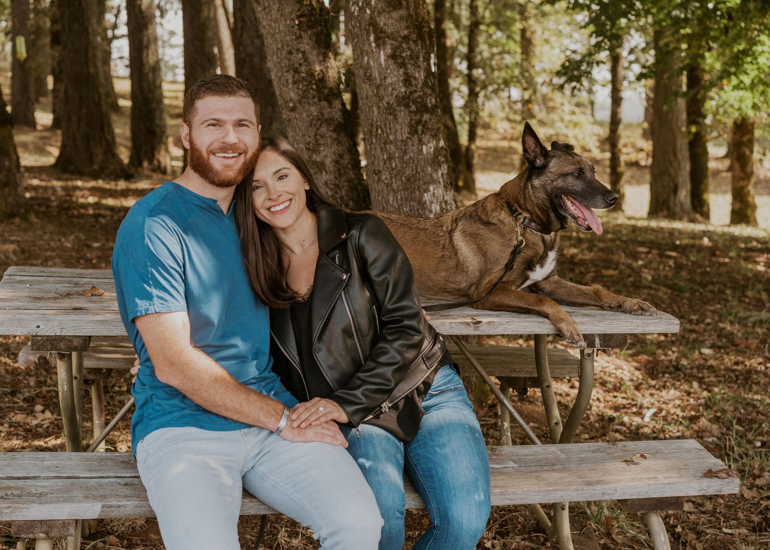 Portrait of the newly engaged couple with their military service dog