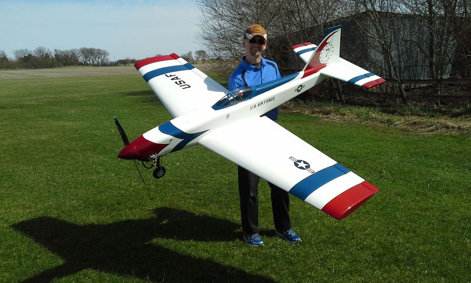 Man poses with Radio Control Airplane
