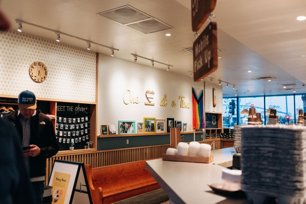 Modern cafe interior with minimalist wall art and wooden furnishings.