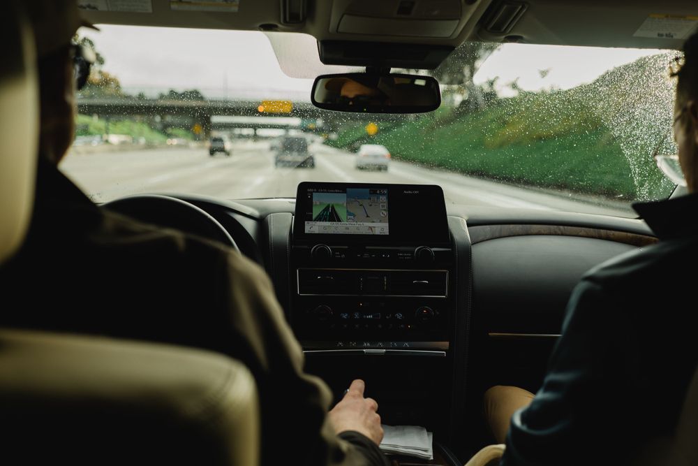 Interior view of car dashboard and navigation system while driving.