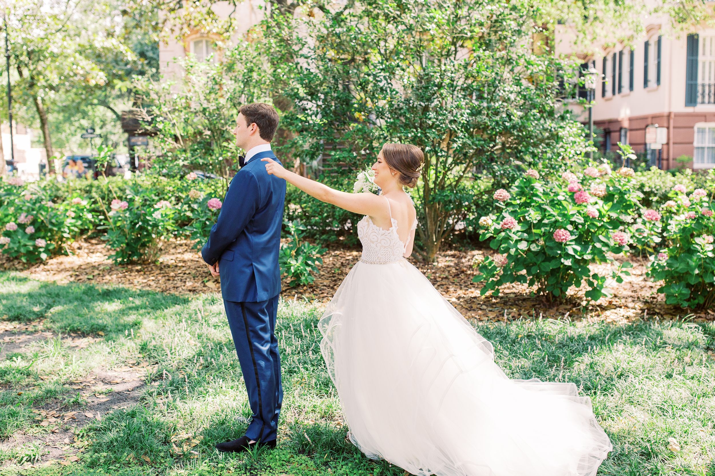 bride and groom in monterey square doing first look in downtown savannah, ga